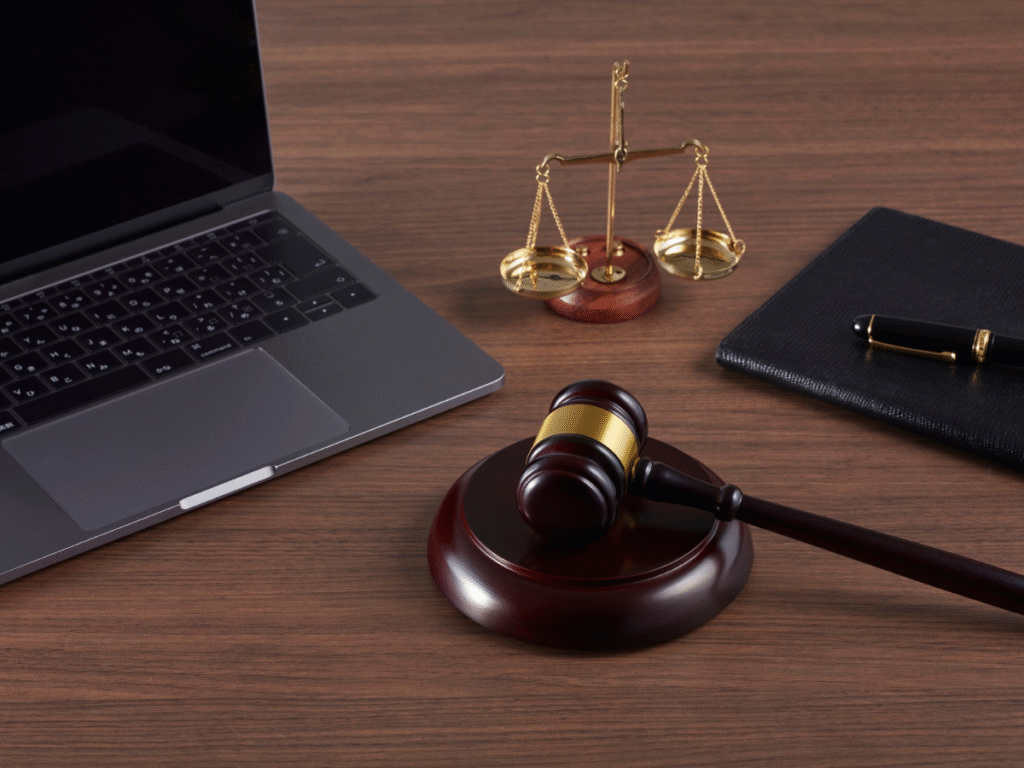 Judge’s gavel, scales of justice, and laptop on a desk representing legal analysis of high profile cases and newsjacking strategies to boost law firm online visibility