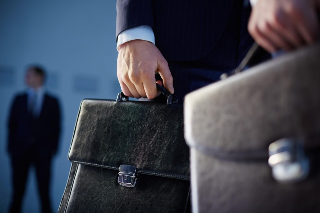 man in suit carrying a brief case